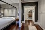 The wallpaper behind the bed helps provide a dramatic contrast