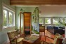 The third floor serves multiple functions; Anatoliy’s office, family room and a sauna. Friend and neighbor Yulia Godiashcheva painted the birch murals. “During Seahawks games we’re always going between the TV and the sauna,” says Stephanie. (Benjamin Benschneider/The Seattle Times)