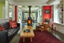 Rooms, defined by color, flow one into the other. Windows from all sides usher in light. The Hearthstone fireplace rotates to face either the dining or living room. Anatoliy made the coffee table, salvaged Doug fir from old basement beams. Stephanie’s father made the chair. (Benjamin Benschneider/The Seattle Times)