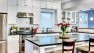 Queen Anne Craftsman – White cabinets in the kitchen with an island.