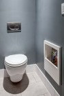 Seattle Box Remodel – Board & Vellum – Built-in magazine storage in the toilet room.