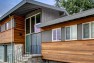 Split Level Exterior Makeover: The Modern Split – Board & Vellum – Natural wood siding paired with gray paint.