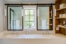 Double vanity with sliding mirrors over windows. – Remodel in a Tudor-style home: Morning Light Master – Board & Vellum