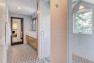 Master bathroom with a shower with a window. – Remodel in a Tudor-style home: Morning Light Master – Board & Vellum