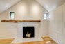 Hearth with salvaged, rough-sawn, asymmetric mantel. – Remodel in a Tudor-style home: Morning Light Master – Board & Vellum