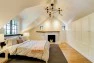 Master bedroom under a gabled dormer. – Remodel in a Tudor-style home: Morning Light Master – Board & Vellum