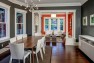 Seattle Box Remodel – Board & Vellum – Dining room open to the living room, separated by historic columns.