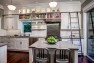 Seattle Box Remodel – Board & Vellum – Kitchen with a rolling ladder to reach the high cabinets.