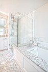 Carrara marble tile in the master bathroom. – Addition on Three Floors – Board & Vellum