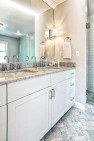 White painted cabinets in the master bathroom. – Addition on Three Floors – Board & Vellum