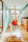 Under the Eaves – Second Story Remodel – Hanging chair in kids bedroom.