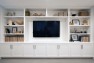 A wall of built-ins for a family room media center. – Addition on Three Floors – Board & Vellum
