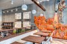 Oasis Tea Zone Capitol Hill – Walnut tables with pendants. – Retail Café Design