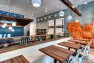 Oasis Tea Zone Capitol Hill – Wood café tables with banquette seating. – Retail Café Design