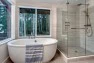 Split Level Remodel – Sammamish Split by Board & Vellum – Freestanding vessel tub with a frameless glass shower.