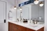 Split Level Remodel – Sammamish Split by Board & Vellum – White bathroom with wood vanity.