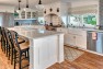 Kitchen with white cabinets and farmhouse details. – Gut and Remodel of a 1960s-era Home – Sound Landing – Board & Vellum