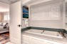 Tub with built-in storage cabinets and shelves. – Sound Landing