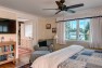 Master bedroom with peek to walk-in closet with built-in storage. – Gut and Remodel of a 1960s-era Home – Sound Landing – Board & Vellum