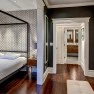 A view from the bedroom towards the bathroom in a remodeled home’s primary suite. – Custom Residential Design at Board & Vellum