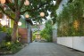 Paper lanterns hang in a tree over the driveway. – Urban Yard at The Seattle Box – Board & Vellum