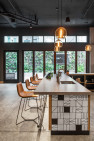 Leather bar stools aligned at a bar in an apartment amenity space.