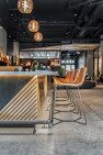 Leather bar stools in a row at the bar counter in an apartment lounge.