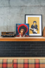 Vintage radios, and a Jimi Hendrix album and art print lean on a shelf.