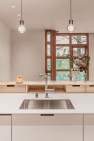 Small drawers in the bar top offer extra storage in this Petite Condo Kitchen, by Board & Vellum.