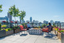 A rooftop fire pit with a view of the city skyline.