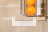 Oranges in a pull out pantry drawer, in this Petite Condo Kitchen, by Board & Vellum.
