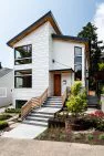 Concrete stairs approach the front entry of this new contemporary home in Fremont.