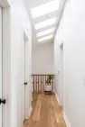 A row of skylights over a hallway lets in plenty of natural light.