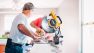 A contractor at work on the job with a table saw.