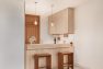 A view of a small ADU kitchen after a remodel to open up the kitchen to the living room.