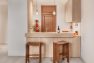 A view of a small ADU kitchen before a remodel to open up the kitchen to the living room.