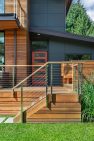 A large front porch with built-in benches offers a welcoming spot for family and guests to gather. — Cloverdale House – Second Story Addition by Board & Vellum