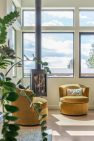 A free-standing wood stove creates a cozy gathering spot in the living room. — Cloverdale House – Second Story Addition by Board & Vellum