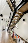 Beautiful wood and steel open-riser stairs connect the levels of the home. — Cloverdale House – Second Story Addition by Board & Vellum