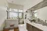 This bathroom features a raised tub in a wet room space with a shower with a view. — Cloverdale House – Second Story Addition by Board & Vellum