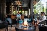 Gathering around a fire pit at a coffeeshop at the Lucille on Roosevelt: Armistice Coffee & Cocktails. – Retail design by Board & Vellum