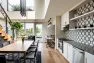 View of the clubroom amenity space at the Lucille on Roosevelt from the entry, looking toward the shared kitchen and dining areas. – Interior design by Board & Vellum