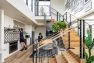 View of the clubroom amenity space at the Lucille on Roosevelt, peeking over the stair toward the communal dining table. – Multifamily Club Room