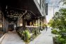 One entry to the lobby passageway at the Lucille on Roosevelt is flanked with a raised patio for café seating.