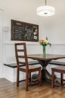A breakfast nook with a chalkboard showing the week's meals.