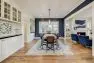 A dining room with large built-in China cabinet and blue walls.