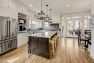 Candelabra chandeliers over the kitchen island in a Craftsman home. – Board & Vellum Custom Home