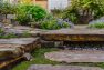 Tree of Life Backyard – Detail at natural stone pavers with ground cover. – Landscape architecture at Board & Vellum