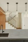 View from the kitchen sink towards the stairwell at the Condo at the Market – Modern Condo – Board & Vellum