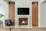 A fireplace and built-in storage in a modern condo unit.